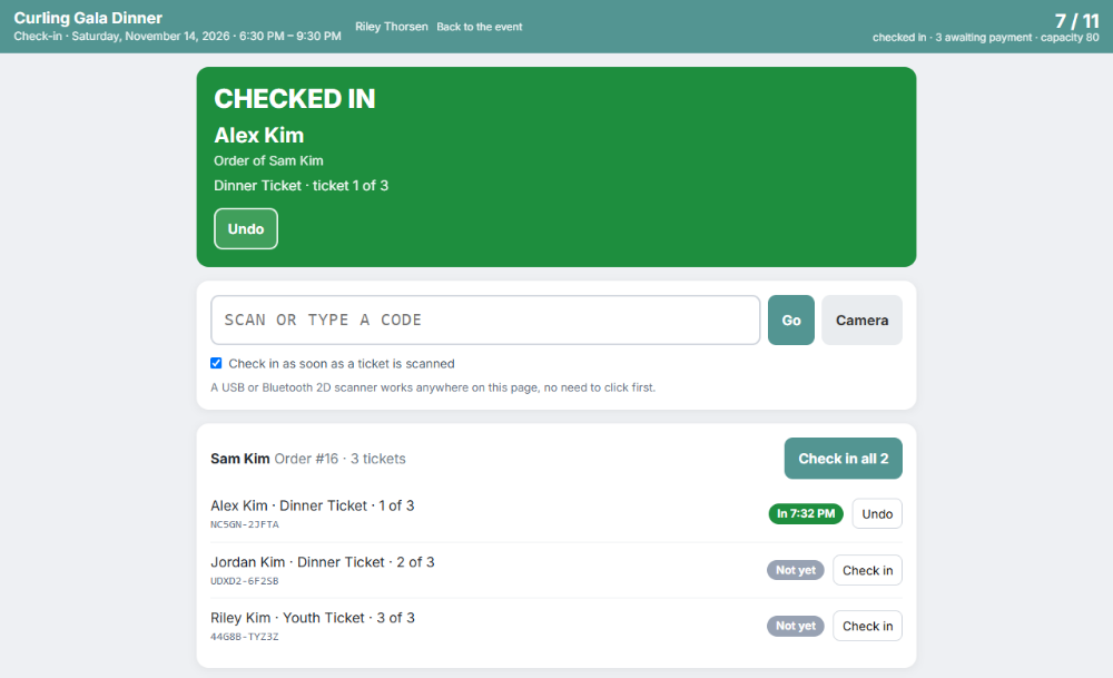 The GoodBooks door check-in screen for a gala dinner: a green Checked In banner for one guest, a box to scan or type a ticket code, and the rest of that guest's party with Check in buttons